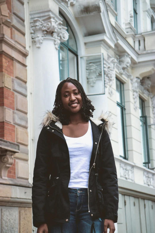 a black woman standing in front of a building