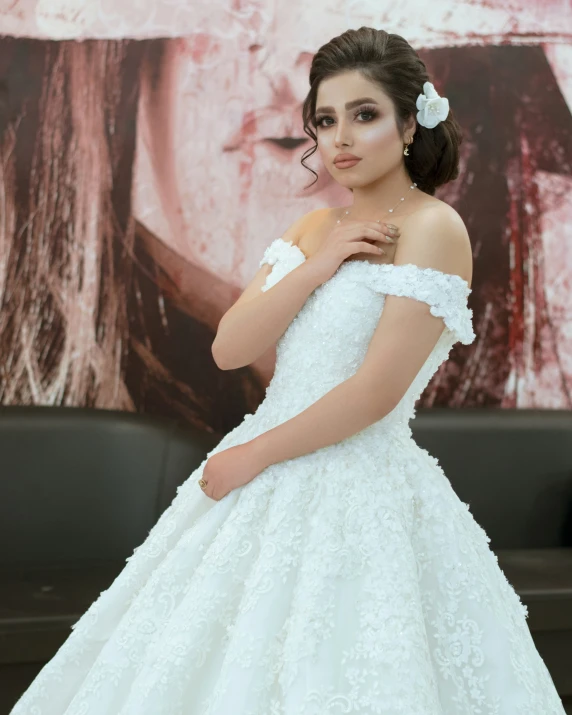 the bride is posing for a picture in her gown