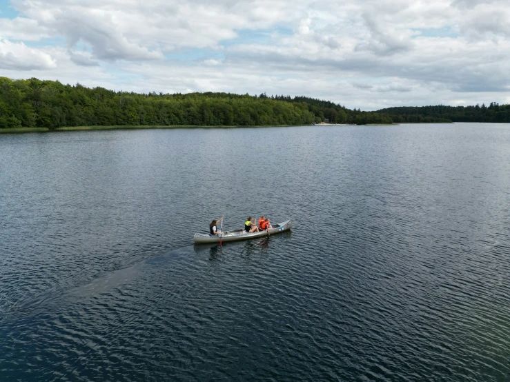 several people are riding in a boat on the water