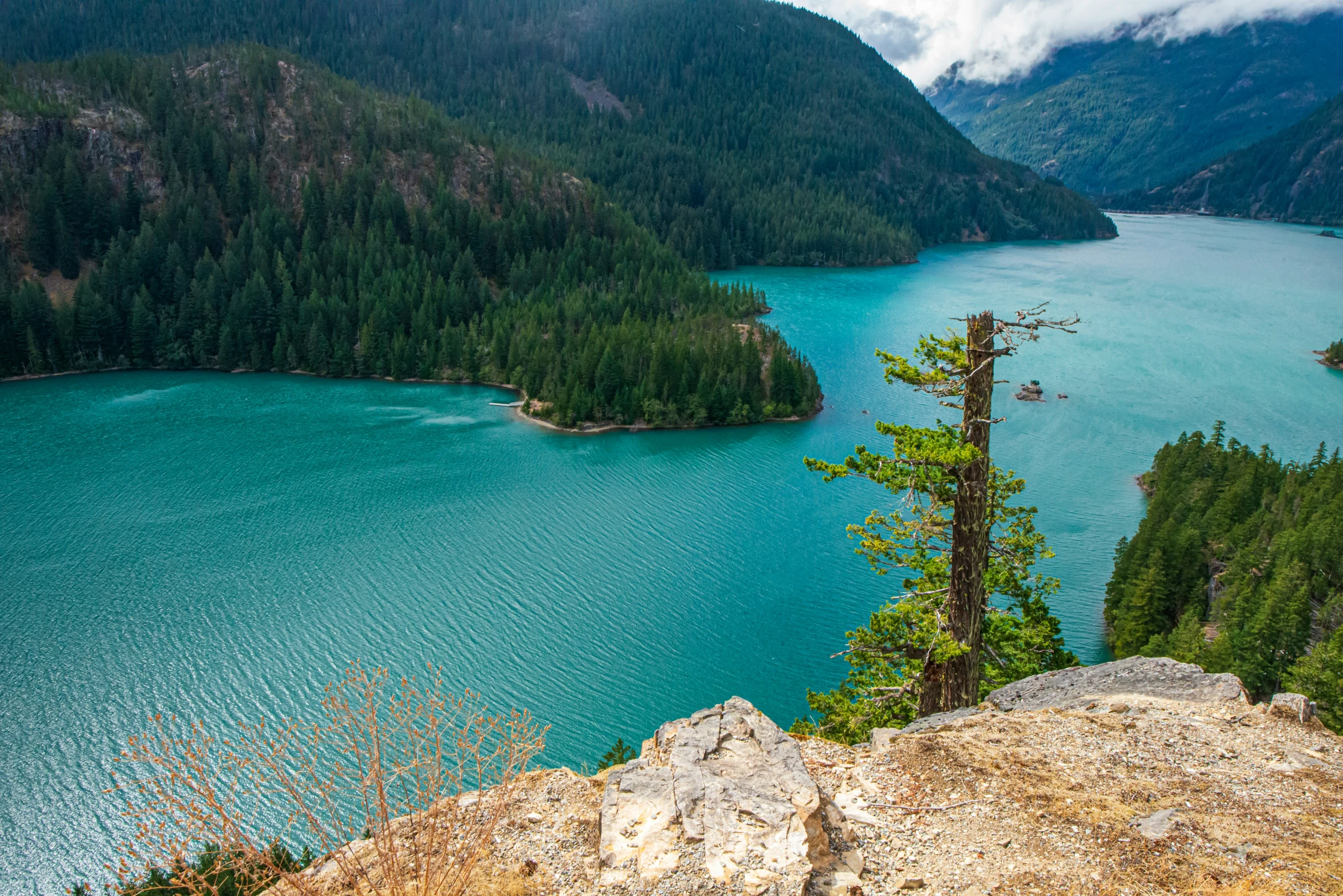 a person stands at the edge of a large lake