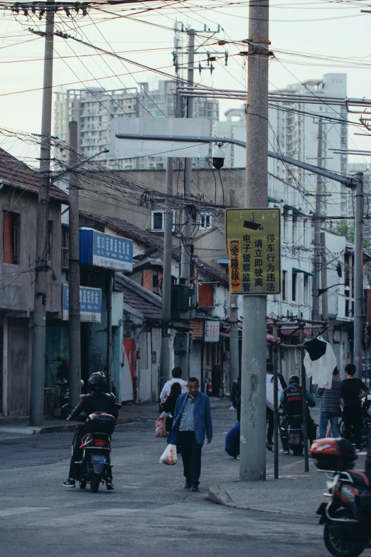 a group of people crossing the street in an urban area