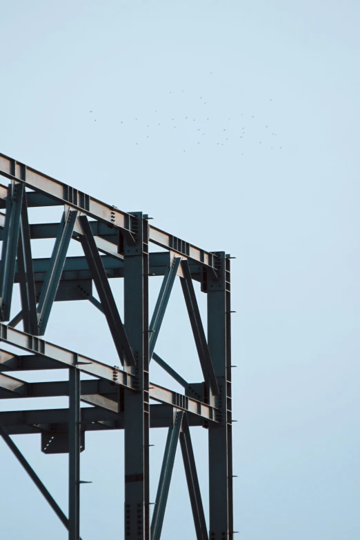 a airplane flying in the sky near a wooden frame