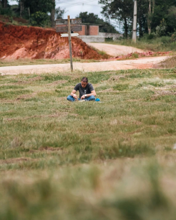 a man laying on the grass with his dog