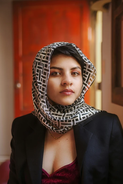 woman in black coat wearing patterned head cover