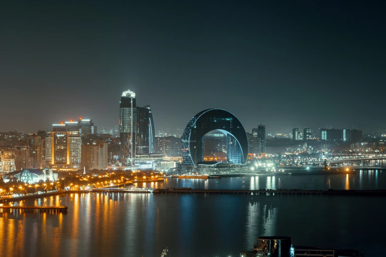 a city is lit up and next to some buildings