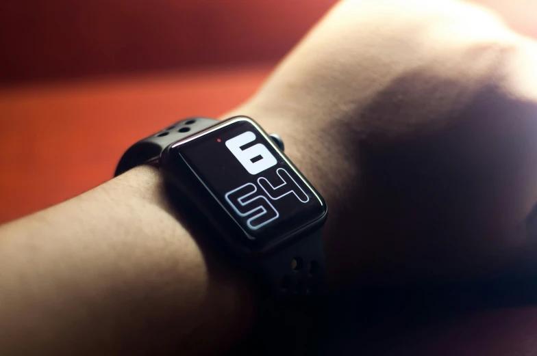 a wrist with an electronic watch display on it