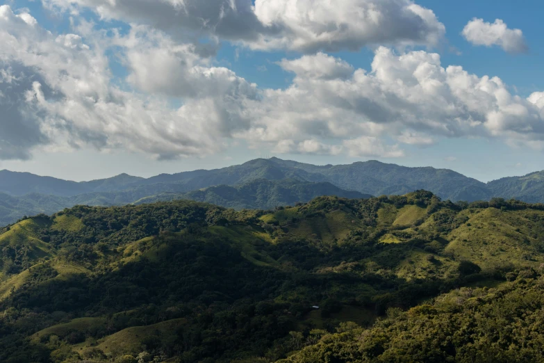 a mountain scene with mountains and some clouds in the sky