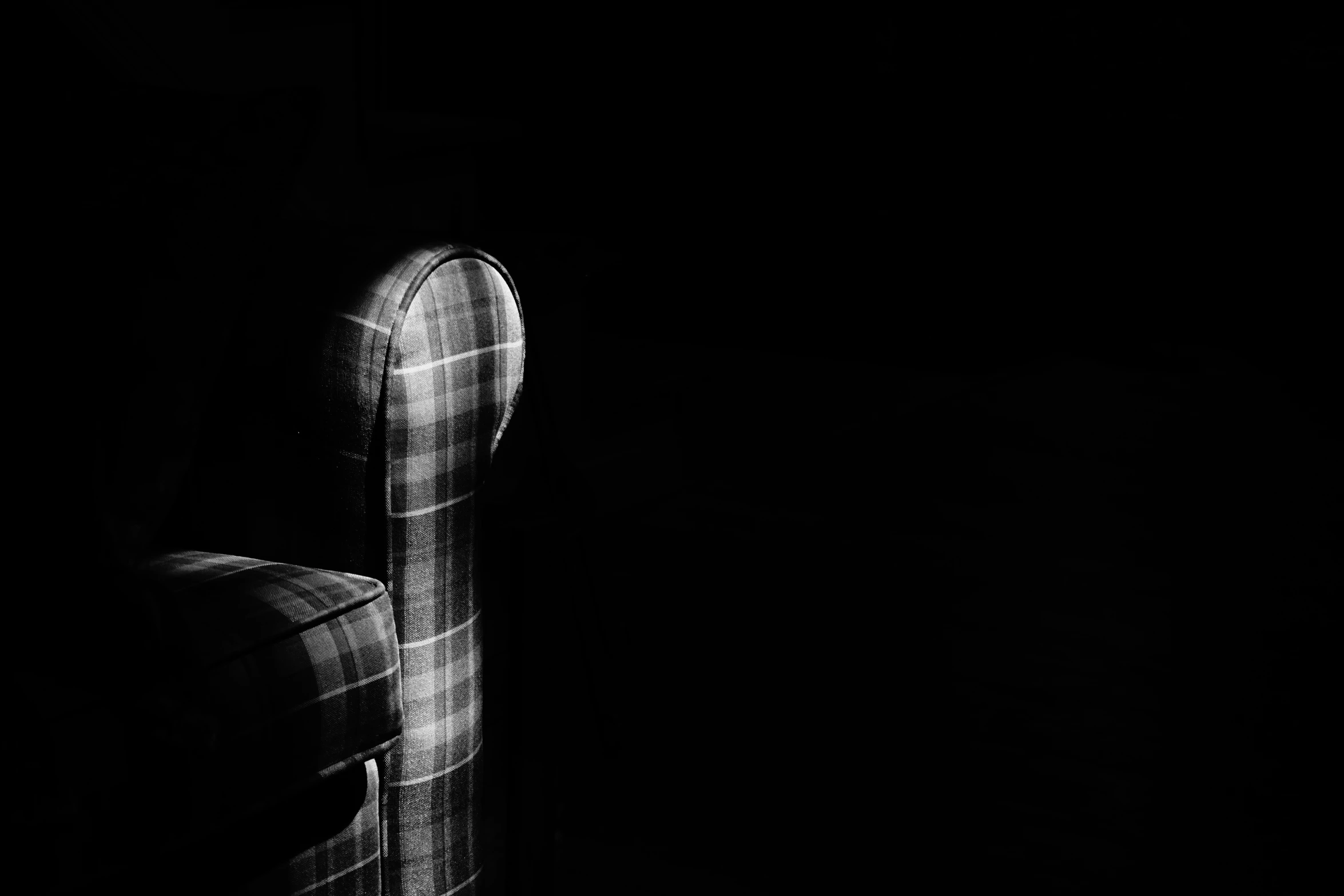 black and white po of chair in dark room