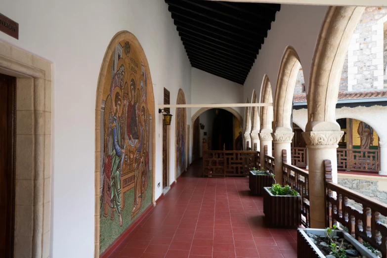 a beautiful hallway with stone arched walls and brick tiled floors