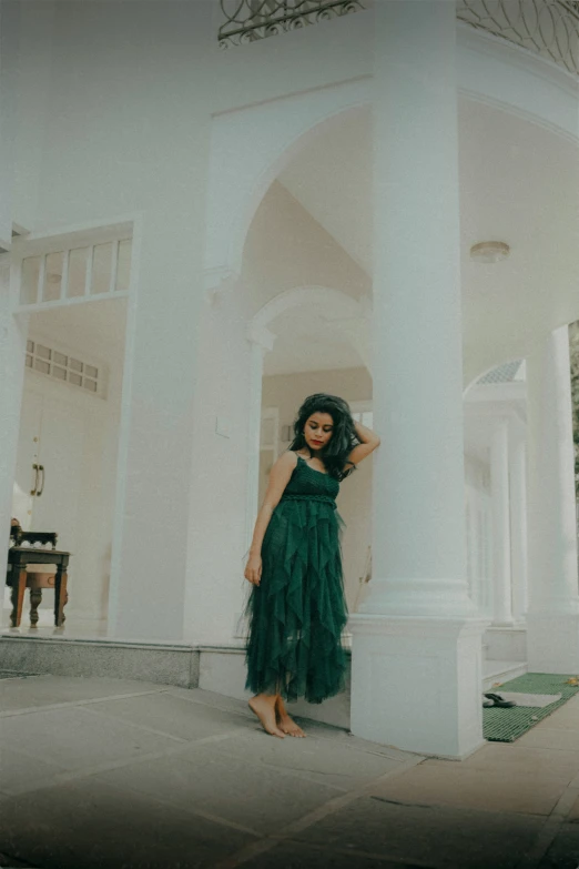 a woman standing in front of a building with columns