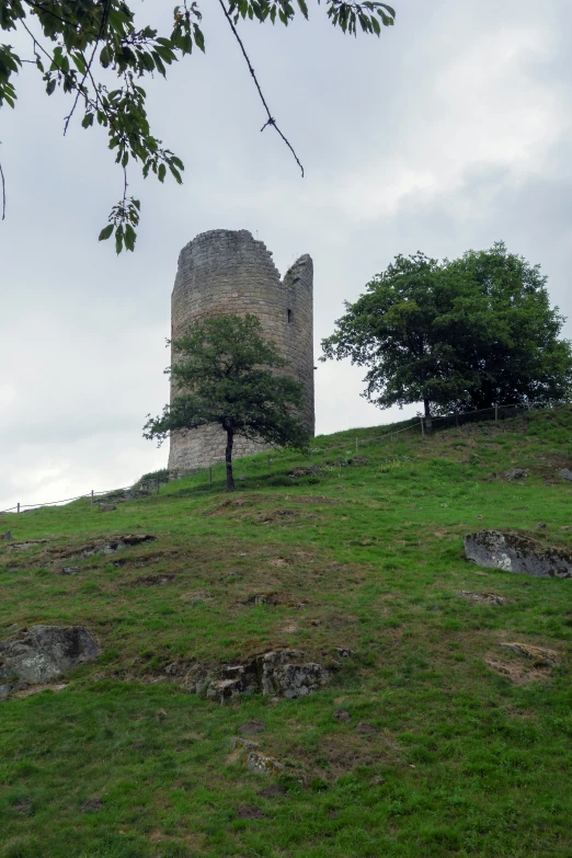 an image of a stone tower on top of the hill