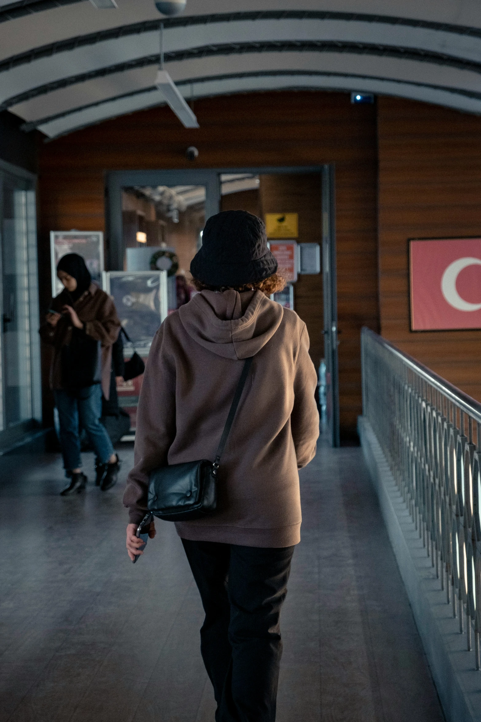 a man is walking up some stairs holding a cell phone