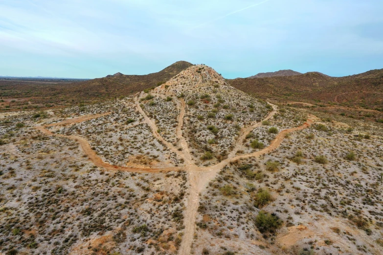 dirt trail surrounded by low hills and scrubby land