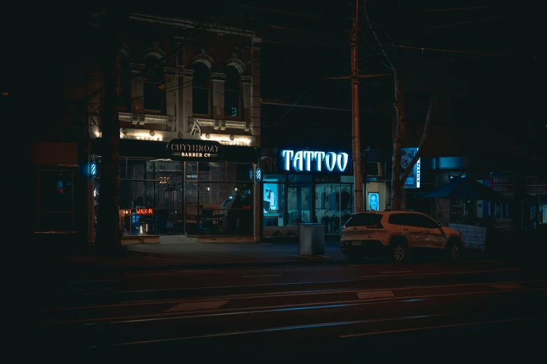 an intersection in the dark of night with lights on