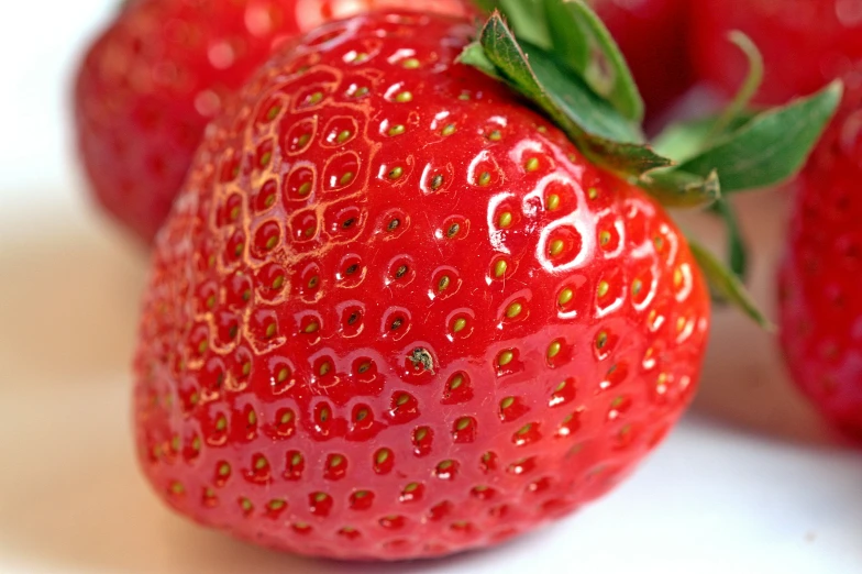 close up of an strawberry with the stem still attached