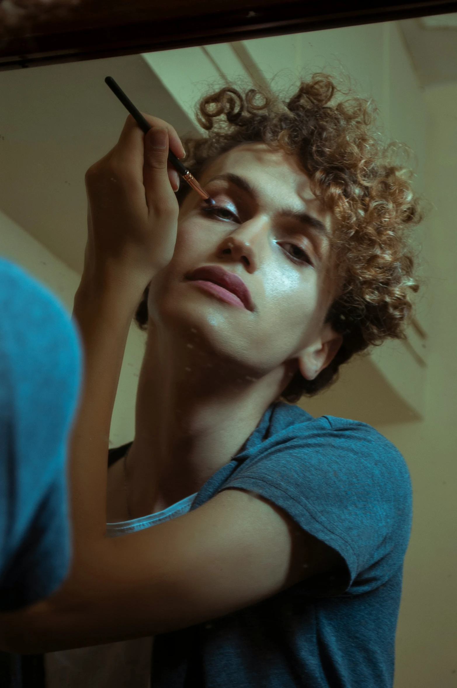 a young man brushes his hair with a brush