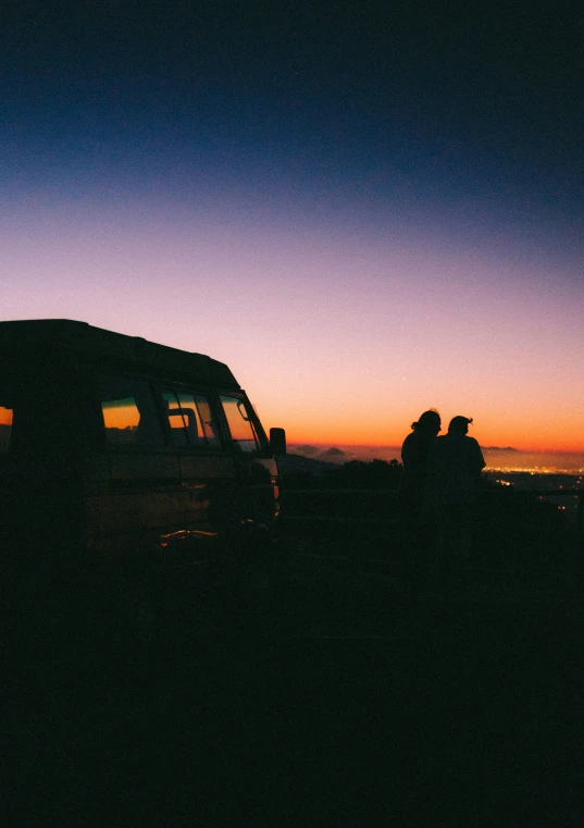 there is some van with two people sitting on the front