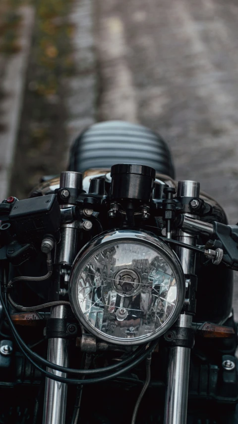 close up view of headlight and handlebars on a motorcycle