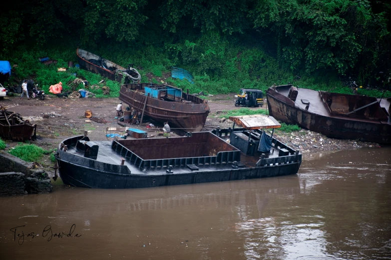 a boat traveling through a muddy river filled with junk