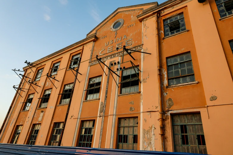 an abandoned building sits empty against the blue sky