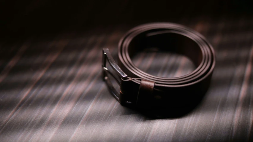 an elegant leather belt on top of a table