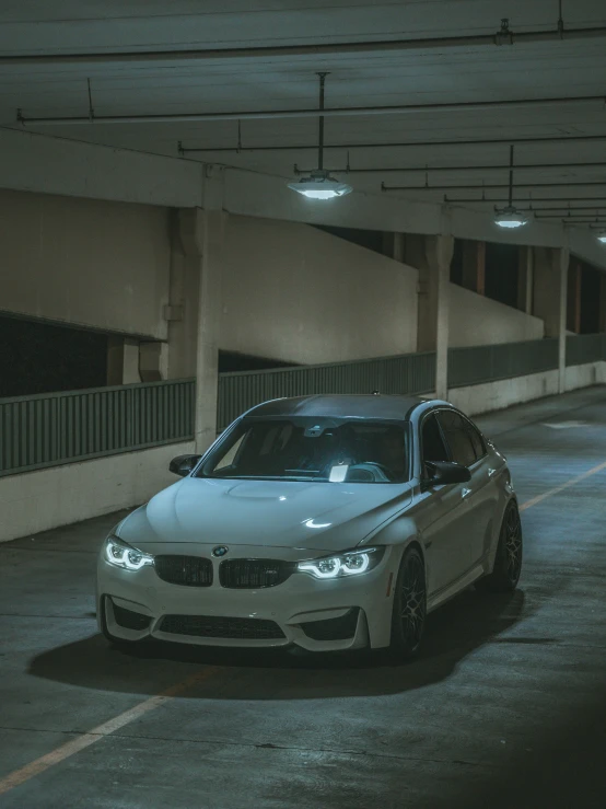 the bmw car is parked in a parking garage