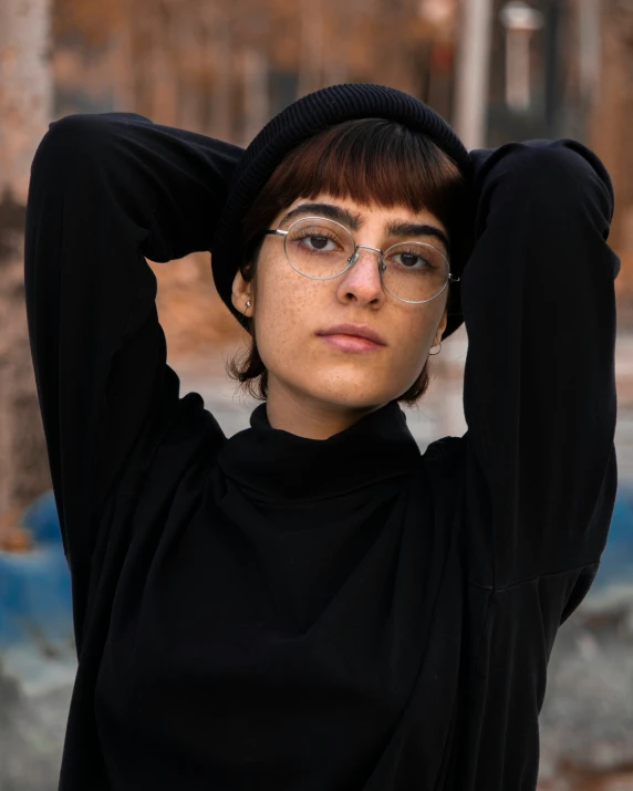 a woman wearing glasses and a black hat