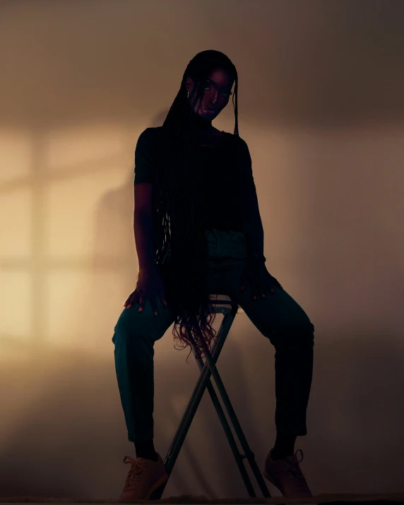 a woman is sitting on a chair in front of the shadows