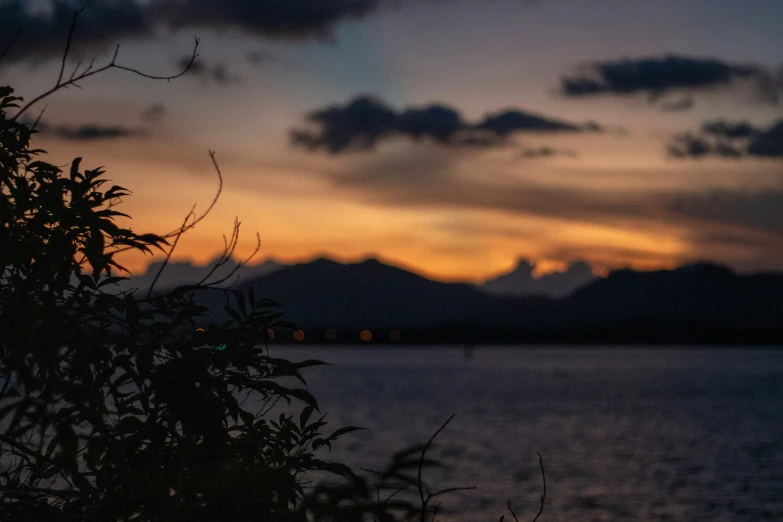 a sunset in front of a calm lake