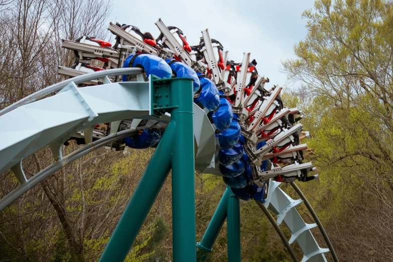 a roller coaster with multiple people riding it