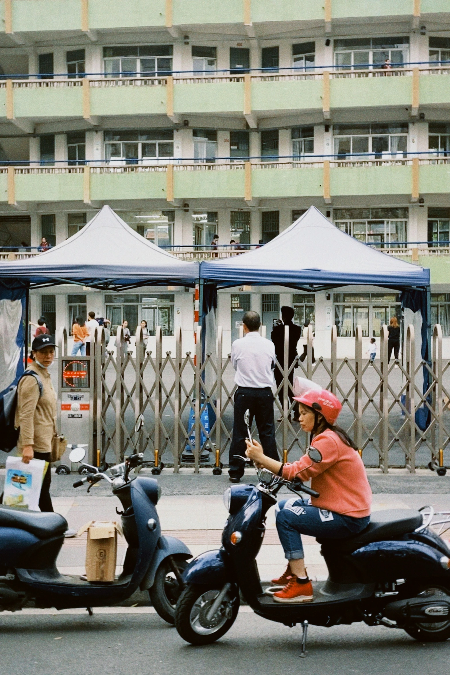 the two women are riding their motorized scooters