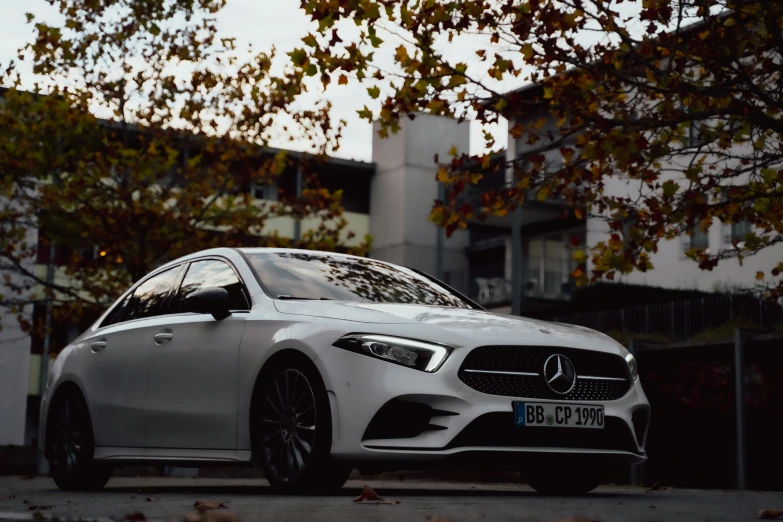 white mercedes cla in front of some building