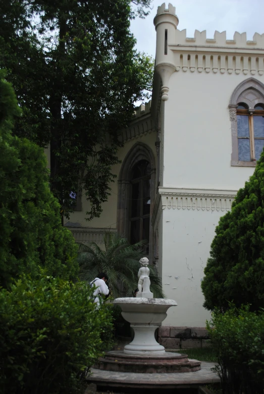 the fountain in front of a large building is standing still