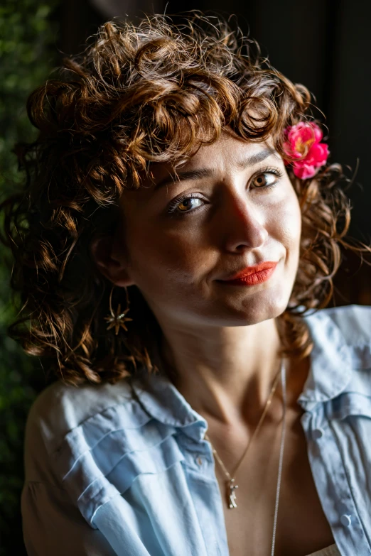 a beautiful young lady with red flowers in her hair