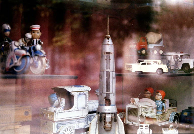 a group of toy vehicles and cars sitting on display