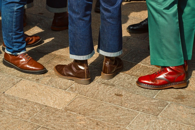 men in brightly colored shoes are standing up close together