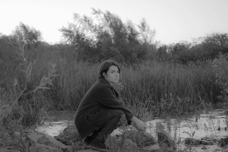 a woman in a shawl sitting on the ground