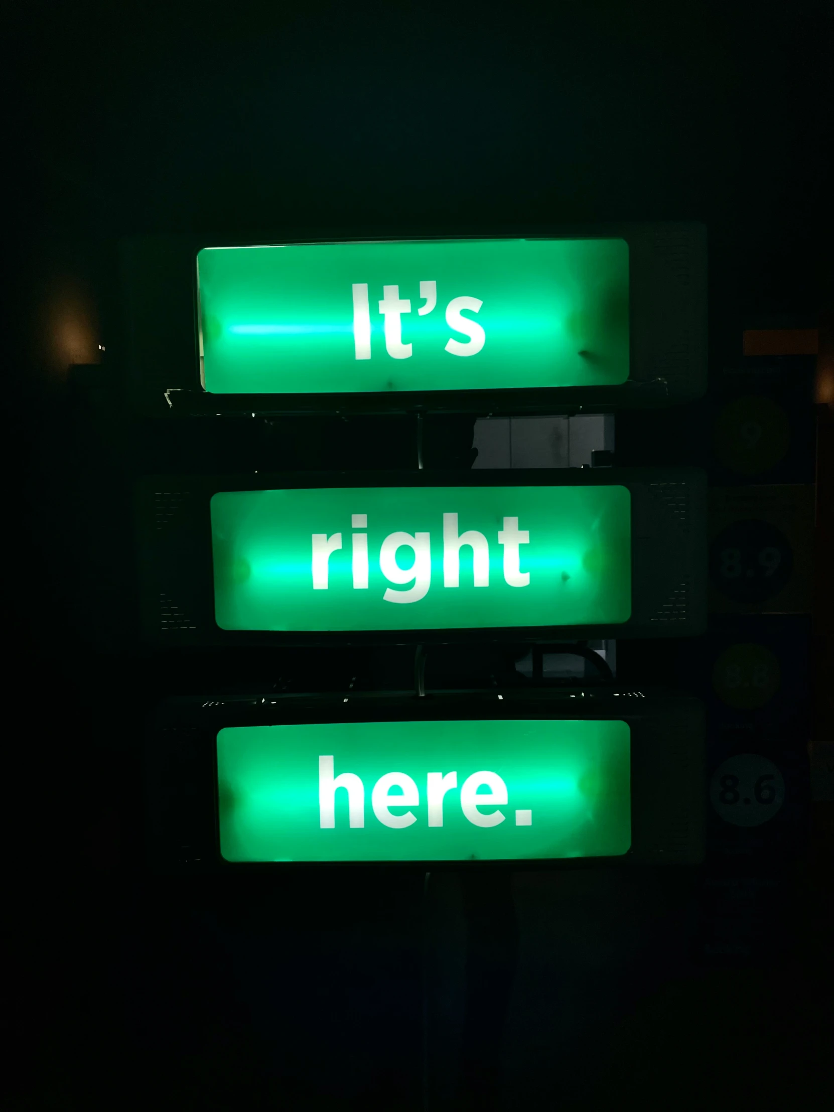 three green lights show different colors on one sign