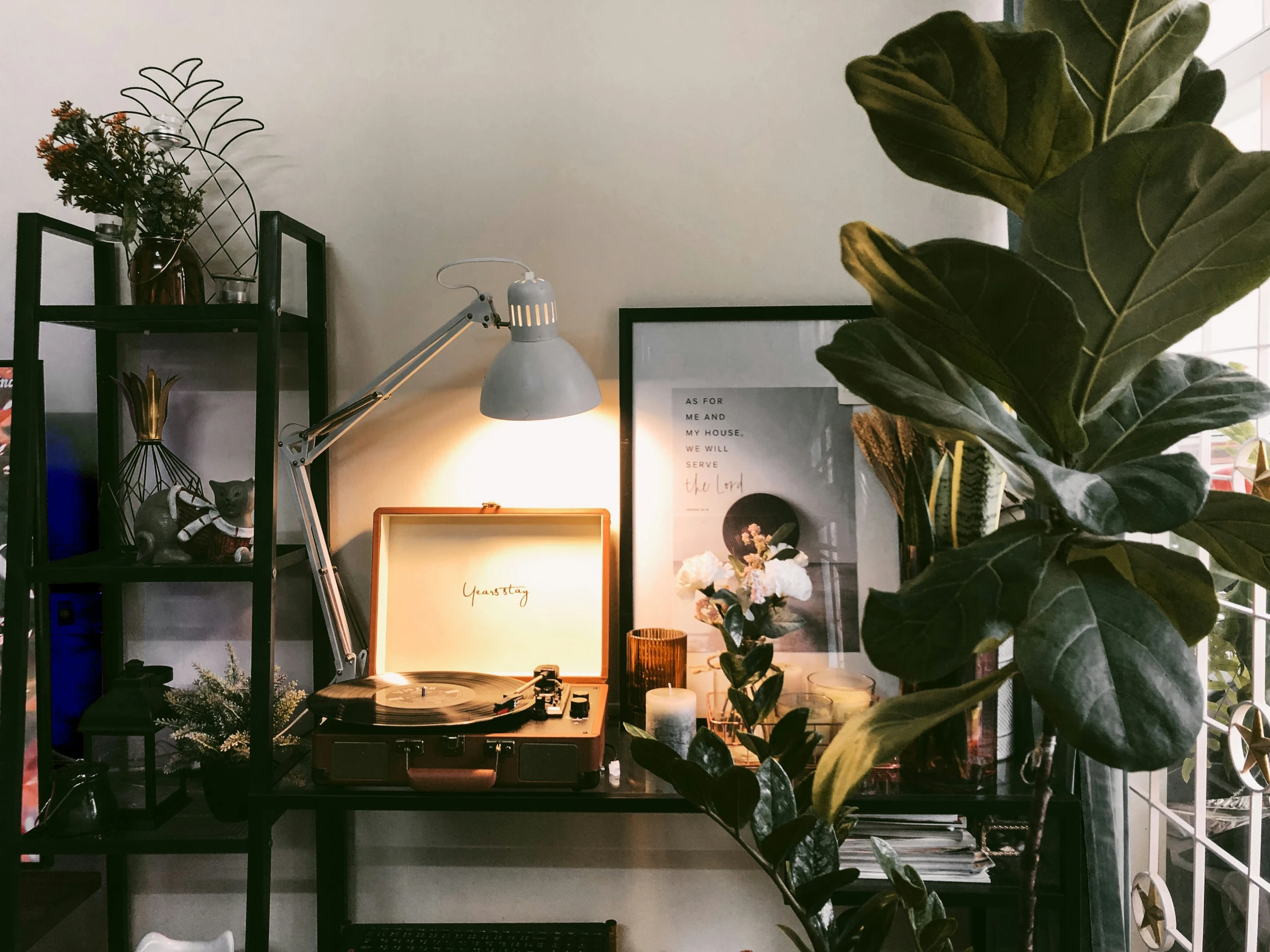 a cluttered home office with a computer screen