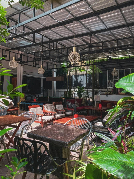 a couple of chairs sitting under a metal roof