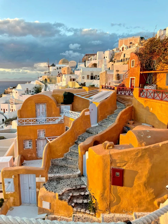 many orange buildings next to the water and houses