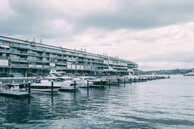 a line of boats floating on top of a body of water