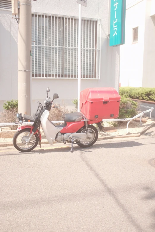 a motorcycle parked in front of a building with an attached trunk