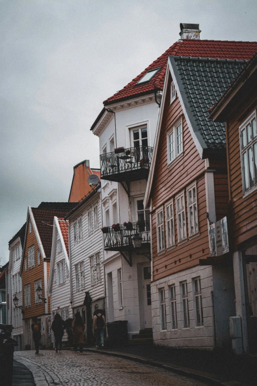 many wooden buildings lined on the side of the street