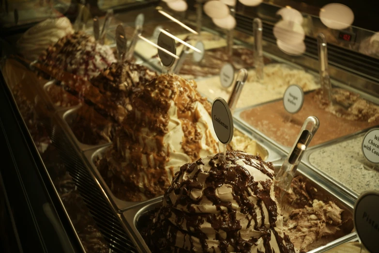 a display case with lots of ice cream and cookies