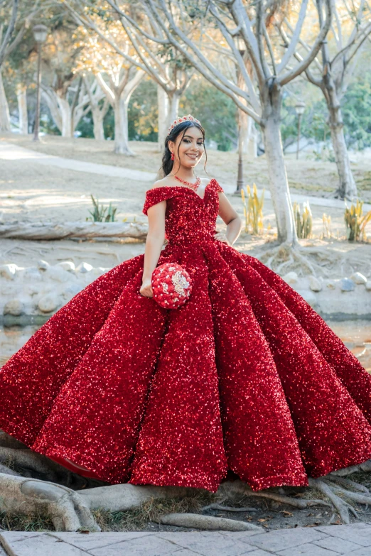 a woman wearing a red gown with sparkle in her dress