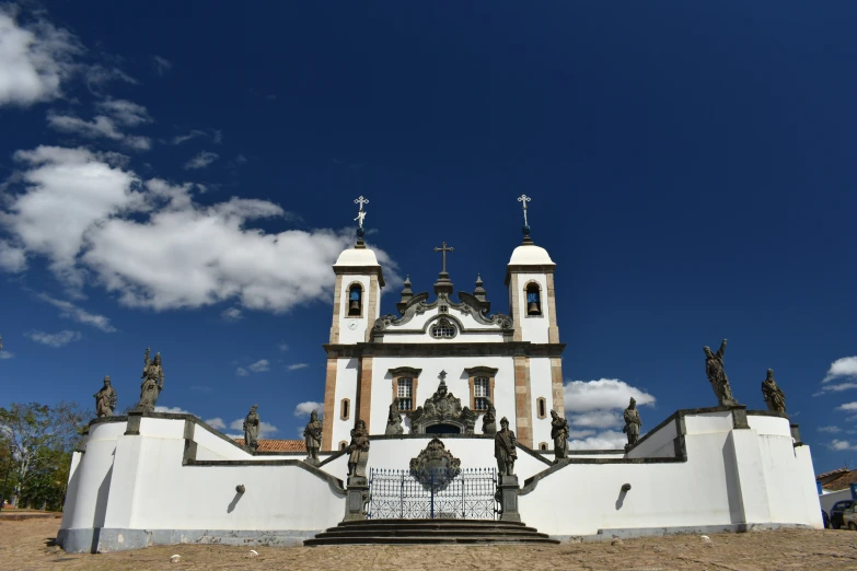 a large church with statues on it's side