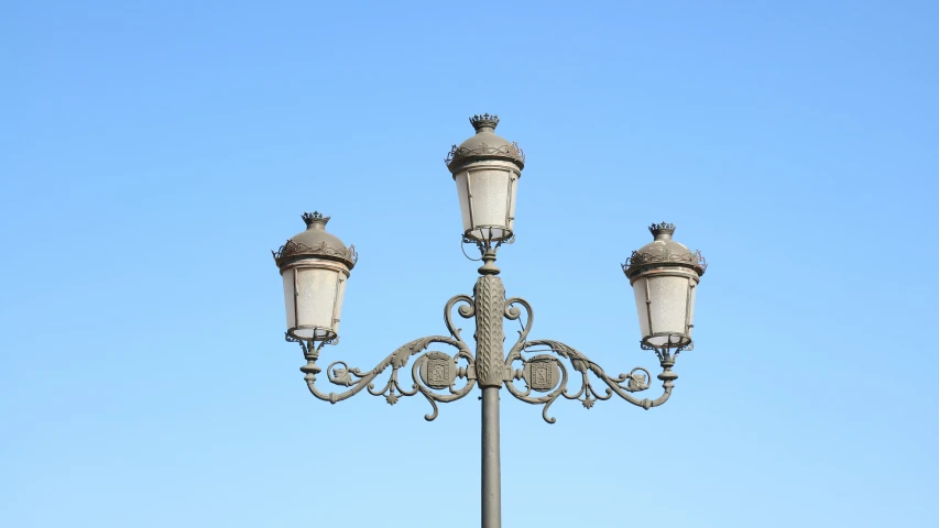 an iron post with three lights on it