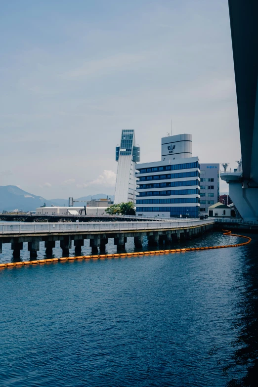 a bridge leading to a large body of water with buildings