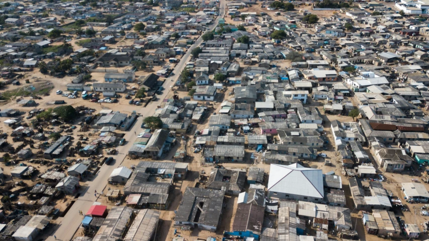 an aerial view of shacks and buildings and dirt field